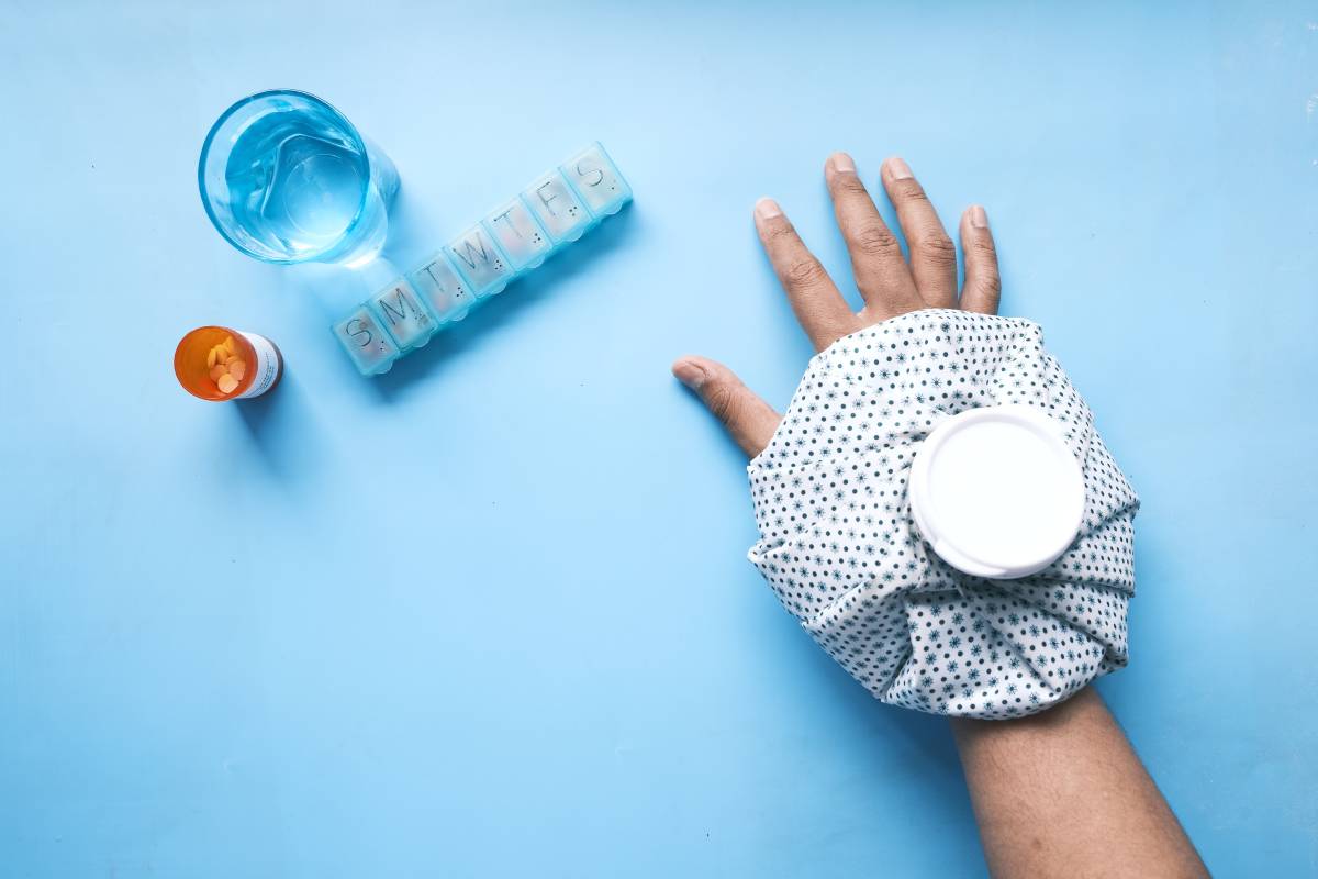 Young man hands suffering wrist pain, and applying cold water on injury spot