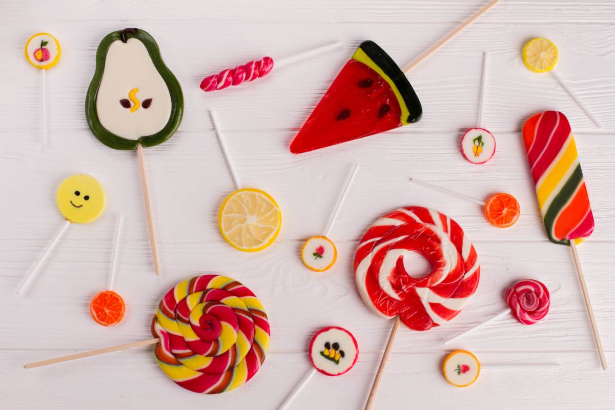 Composition with tasty colorful candies on wooden background.